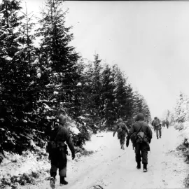 Soldiers of the 83rd Division moving toward the front in the Houffalize sector, Belgium